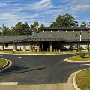 Single-story building with skylights and parking lot
