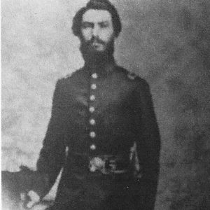 Man with short dark hair and beard dressed in military uniform